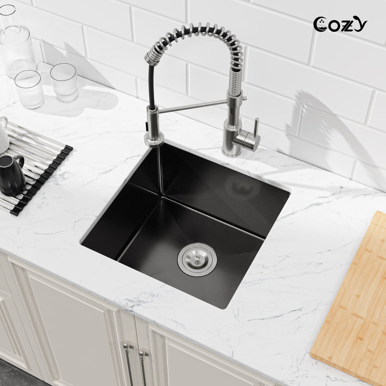 Angled view of Cozy 18-inch matte black undermount single bowl handmade kitchen sink installed on white marble countertop