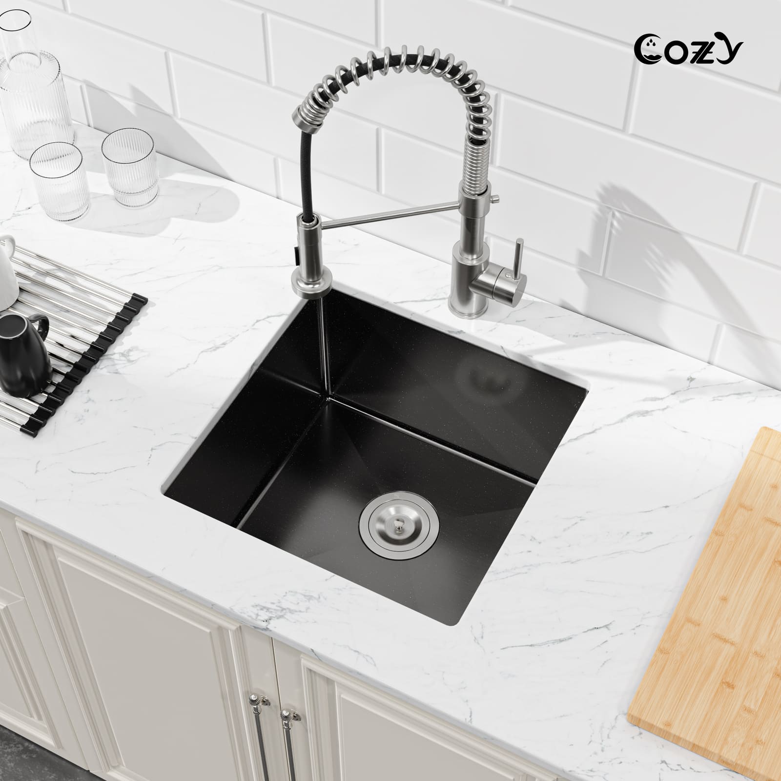 Angled view of Cozy 18-inch matte black undermount single bowl handmade kitchen sink installed on white marble countertop