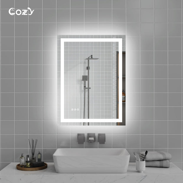 Cozy 24x32 inch backlit and front-lit LED bathroom vanity mirror in a modern setting.