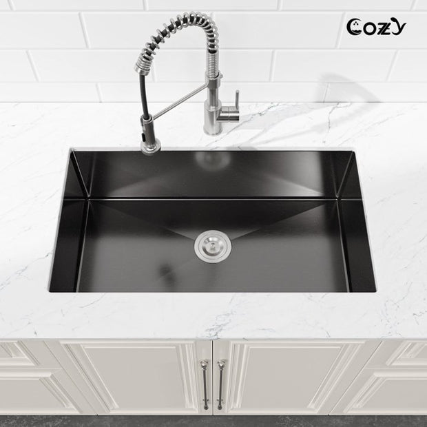 Cozy 33-inch black stainless steel undermount kitchen sink installed on countertop