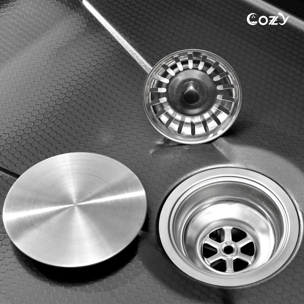 Cozy 33-inch black drop-in workstation single bowl kitchen sink showing stainless steel basket strainer and drain assembly