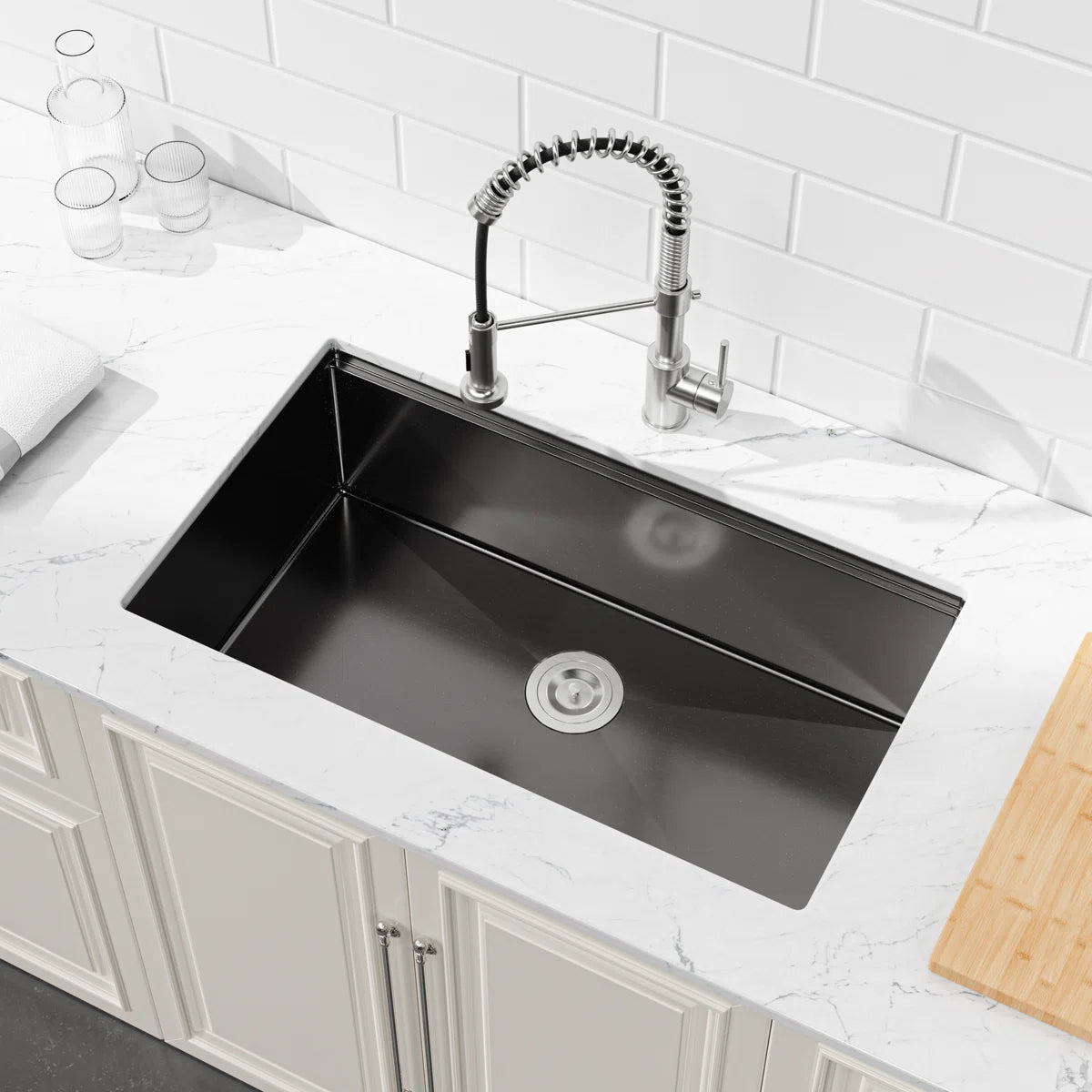 COZY 36-inch undermount matte black single bowl workstation kitchen sink installed in a countertop.