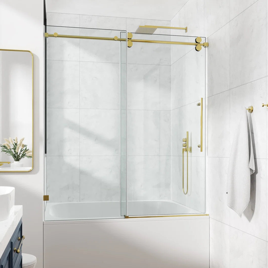 Cozy GD10-4860 Brushed Gold frameless single sliding tub door installed over a bathtub in a modern bathroom.